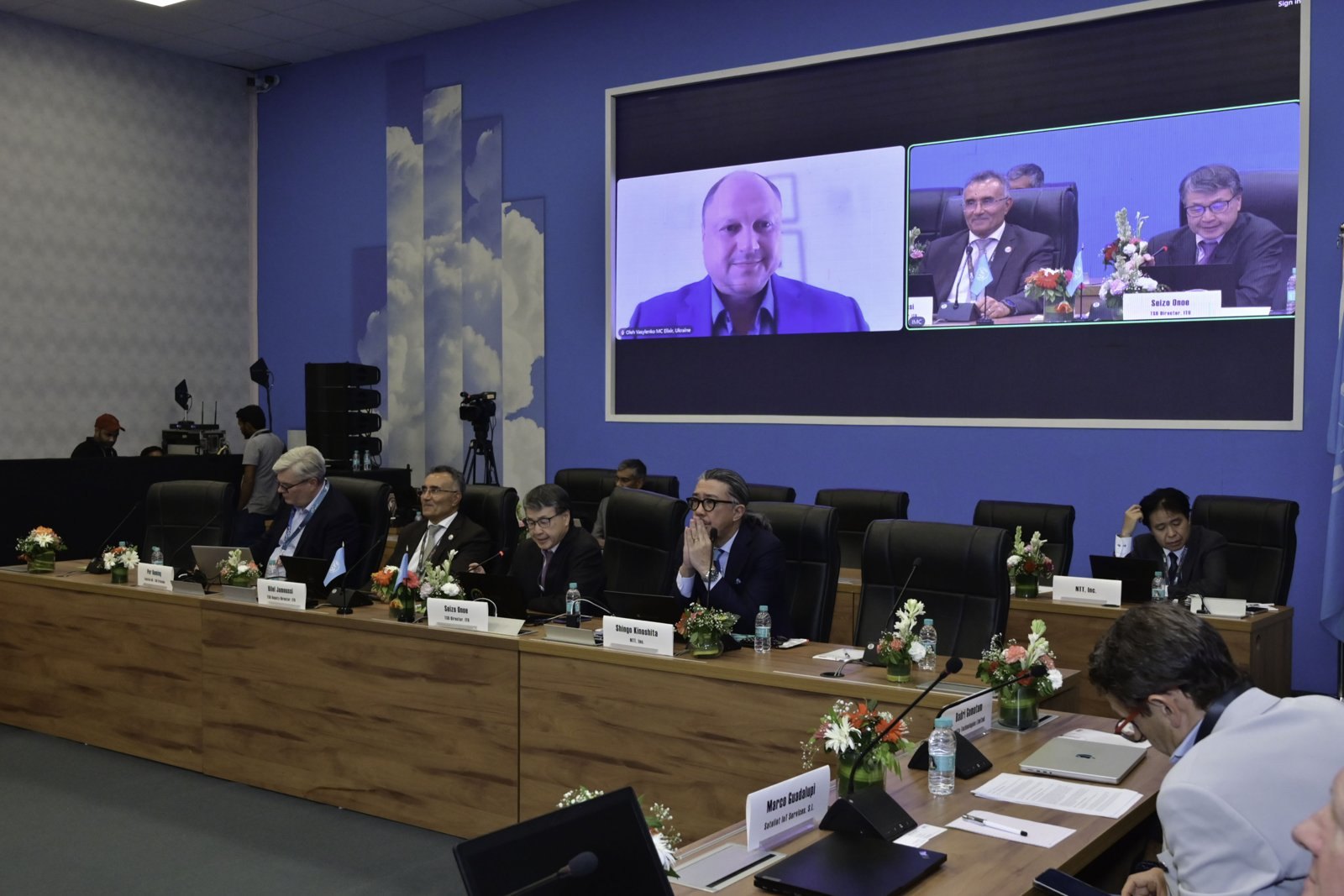 Remote participation from Ukraine shown on the room screen